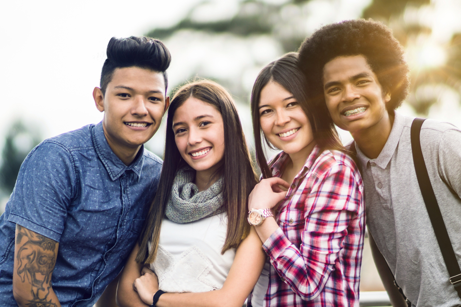 Diverse group of teens smiling at camera